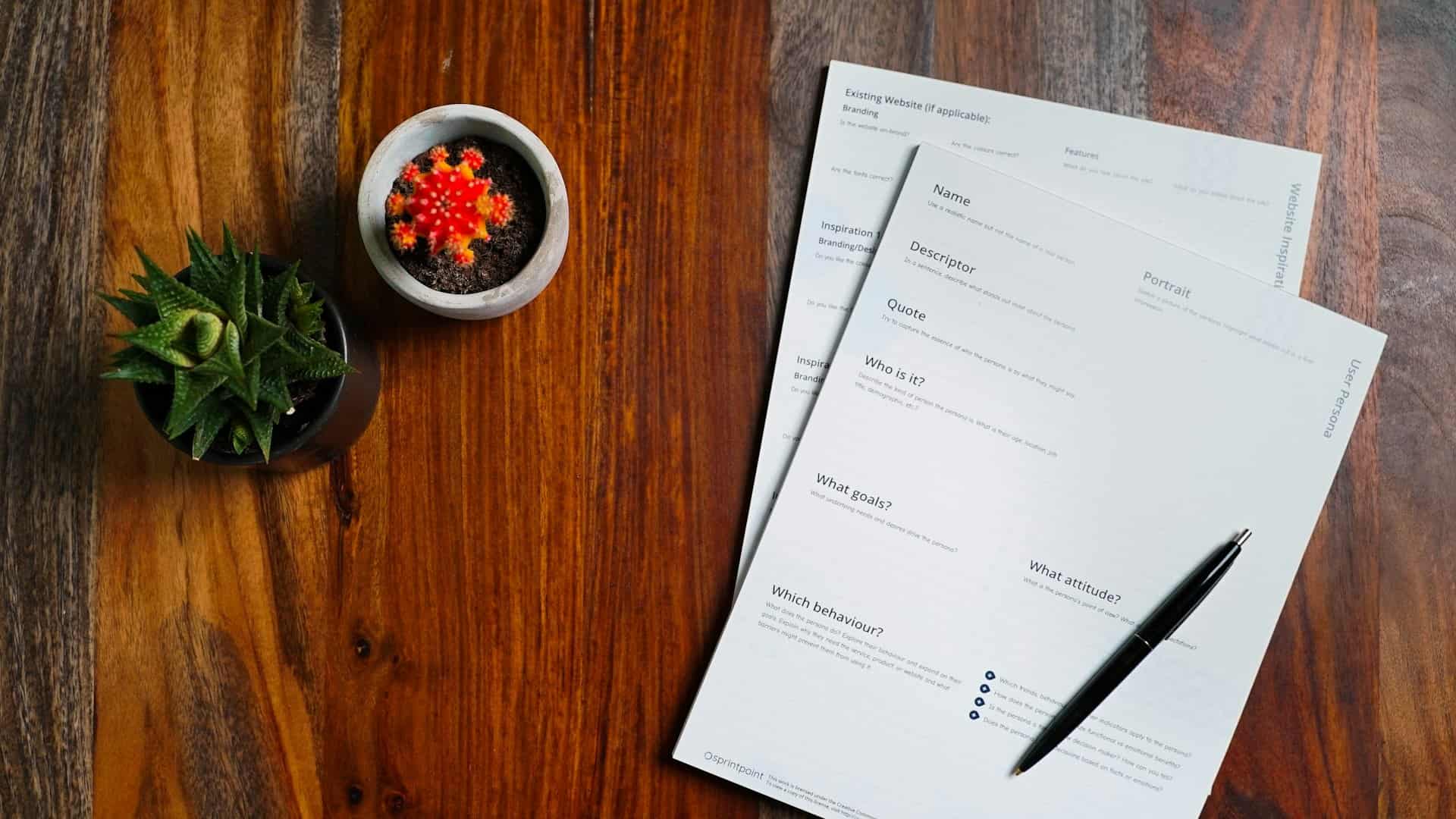 Documents and a pen on a wooden table